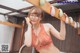 A woman in a red lingerie holding a bunch of eggs.