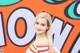A woman in a red and white striped dress posing for a picture.