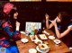 Two women sitting at a table with plates of food.